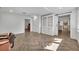 Open-concept living room with herringbone floors, white built-ins, and abundant natural light at 1003 Shore Dr, Kissimmee, FL 34744