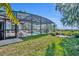 Screened-in pool with fountains and a scenic lake view at 1003 Shore Dr, Kissimmee, FL 34744
