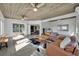 Spacious sunroom with two ceiling fans, tile floors, and access to living room at 1003 Shore Dr, Kissimmee, FL 34744