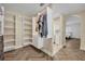 Well-organized walk-in closet with custom shelving, drawers, and access to other rooms at 1003 Shore Dr, Kissimmee, FL 34744