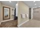 Spacious walk-in closet with built-in storage solutions and wood flooring leading into bath area at 1003 Shore Dr, Kissimmee, FL 34744