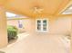Inviting covered back porch featuring a ceiling fan and access to the backyard at 10235 Summer Elm Ave, Clermont, FL 34711