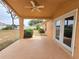 Cozy covered back porch with ceiling fan and direct access to the backyard at 10235 Summer Elm Ave, Clermont, FL 34711