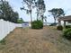 Large backyard featuring mature trees, privacy fence, and storage shed at 10235 Summer Elm Ave, Clermont, FL 34711