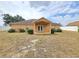 Covered back porch with ceiling fan overlooks an expansive backyard with white fence at 10235 Summer Elm Ave, Clermont, FL 34711