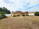 Spacious backyard with white fencing and mature trees surrounding the perimeter at 10235 Summer Elm Ave, Clermont, FL 34711