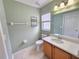 Cozy bathroom with earth-toned walls, tiled floors, and single vanity at 10235 Summer Elm Ave, Clermont, FL 34711