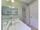Compact bathroom showcases a single sink vanity and a shower stall, maximizing space and functionality at 10235 Summer Elm Ave, Clermont, FL 34711