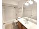 Bathroom featuring a tub, tiled shower, toilet, and a vanity with a mirror and lighting at 10235 Summer Elm Ave, Clermont, FL 34711