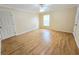 Bright, empty bedroom featuring wood-look laminate flooring and neutral walls offers a blank slate for personalized decoration at 10235 Summer Elm Ave, Clermont, FL 34711