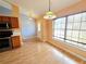 Bright dining area with wood flooring, chandelier and a large window for natural light at 10235 Summer Elm Ave, Clermont, FL 34711