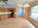 Bright kitchen and dining area with wood cabinets and stainless appliances offers a welcoming space for cooking and entertaining at 10235 Summer Elm Ave, Clermont, FL 34711