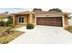 Charming single-story home showcasing attached garage and front landscaping at 10235 Summer Elm Ave, Clermont, FL 34711