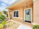 Inviting front porch with decorative glass door, window and well maintained landscaping at 10235 Summer Elm Ave, Clermont, FL 34711