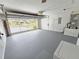 A clean garage with an open door, showcasing painted floor and plenty of space at 10235 Summer Elm Ave, Clermont, FL 34711
