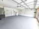 Spacious two-car garage with painted flooring, utility sink, and storage options available at 10235 Summer Elm Ave, Clermont, FL 34711