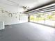 Spacious garage with a washer, fan, and natural light streaming through glass garage door at 10235 Summer Elm Ave, Clermont, FL 34711