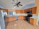 Modern kitchen with stainless steel appliances, wood cabinets, and light countertops at 10235 Summer Elm Ave, Clermont, FL 34711