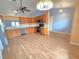 Open-concept kitchen with wooden cabinetry and stainless steel appliances provides ample space for cooking and entertaining at 10235 Summer Elm Ave, Clermont, FL 34711