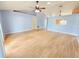 Spacious living room with wood floors and light blue walls at 10235 Summer Elm Ave, Clermont, FL 34711