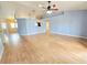 Open living room with vaulted ceilings, wood-look floors, and adjoining spaces at 10235 Summer Elm Ave, Clermont, FL 34711