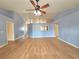 Spacious living room features wood-look floors, vaulted ceilings, and an open floor plan at 10235 Summer Elm Ave, Clermont, FL 34711