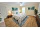 Serene staged bedroom features soft lighting, neutral decor, and plush bedding, creating a relaxing retreat at 10235 Summer Elm Ave, Clermont, FL 34711