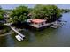 Ariel view of waterfront home with boat dock and watercraft on a sunny day at 1156 Calle Del Norte # C, Casselberry, FL 32707