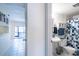 Cozy bathroom features a vanity, toilet, shower-tub combo, and colorful patterned shower curtain at 1156 Calle Del Norte # C, Casselberry, FL 32707