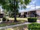 Landscaped courtyard view featuring mature trees, walkways, and building facades at 1156 Calle Del Norte # C, Casselberry, FL 32707