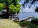 Tranquil lake view from a backyard dock with wooden planks and railings and a bench for seating at 1156 Calle Del Norte # C, Casselberry, FL 32707