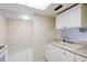 Kitchen area with tile flooring, double sink and pass-through to living area at 1156 Calle Del Norte # C, Casselberry, FL 32707