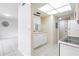 Galley kitchen with white cabinets and appliances, and tile flooring at 1156 Calle Del Norte # C, Casselberry, FL 32707