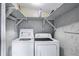 Practical laundry area with white washer and dryer, with convenient shelving for storage at 1156 Calle Del Norte # C, Casselberry, FL 32707