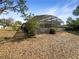 Backyard featuring a screened-in patio and a yard at 12610 Bay Hill Dr, Grand Island, FL 32735