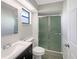 Cozy bathroom featuring a modern vanity, a toilet, and a glass-enclosed shower at 12610 Bay Hill Dr, Grand Island, FL 32735