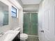 Bathroom featuring a glass shower, toilet, and a black vanity at 12610 Bay Hill Dr, Grand Island, FL 32735