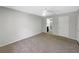 A bright bedroom features neutral walls, tan carpet and a ceiling fan at 12610 Bay Hill Dr, Grand Island, FL 32735