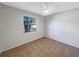 A bedroom with neutral walls and carpeting receives abundant natural light at 12610 Bay Hill Dr, Grand Island, FL 32735