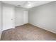 A bright bedroom features neutral walls, tan carpet and a closet at 12610 Bay Hill Dr, Grand Island, FL 32735