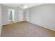 A bright bedroom features neutral walls, tan carpet and a ceiling fan at 12610 Bay Hill Dr, Grand Island, FL 32735