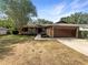 Traditional single story home with a brick facade and well manicured lawn at 12610 Bay Hill Dr, Grand Island, FL 32735