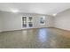 Spacious living room with ceramic floors, ceiling fans and French doors at 12610 Bay Hill Dr, Grand Island, FL 32735