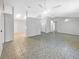 Bright living room with ceramic flooring, multiple ceiling fans, and open layout at 12610 Bay Hill Dr, Grand Island, FL 32735
