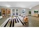 Bright living room boasts natural light, complemented by a stylish striped rug and custom built-in shelving at 12610 Bay Hill Dr, Grand Island, FL 32735