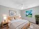 Serene bedroom featuring a comfortable bed, a window with natural light, and minimalist decor at 12610 Bay Hill Dr, Grand Island, FL 32735