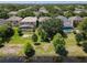 Aerial view showcases a neighborhood with screened-in pools, surrounded by lush trees and landscaping at 12822 Moss Park Ridge Dr, Orlando, FL 32832