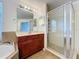 Bathroom offers a tub, glass enclosed shower, and vanity with modern fixtures at 12822 Moss Park Ridge Dr, Orlando, FL 32832