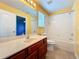 Bathroom featuring a cherry wood vanity, large mirror, and shower-tub combination at 12822 Moss Park Ridge Dr, Orlando, FL 32832