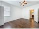 Bedroom with hardwood floors, natural light, and an ensuite bathroom at 12822 Moss Park Ridge Dr, Orlando, FL 32832